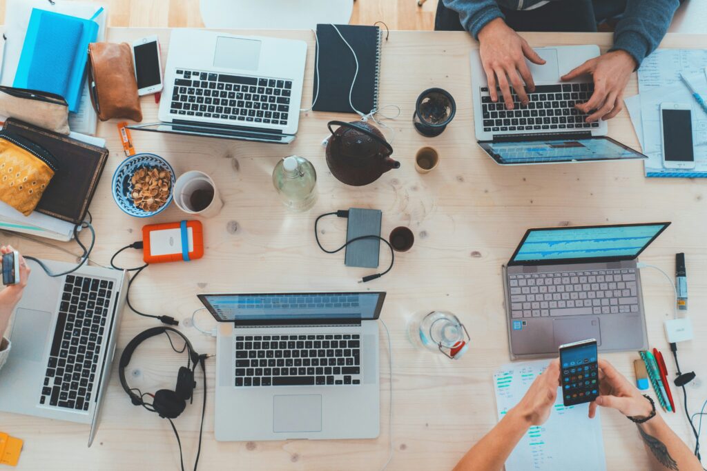 A group of diverse individuals brainstorming ideas around a conference table, engaged in lively discussion.